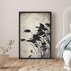 a bedroom scene with focus on the bed and plant art hanging in front of it