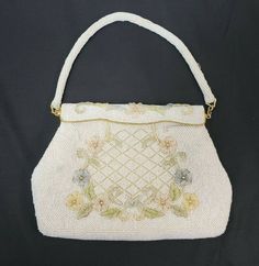 "This is a vintage Debbie Purse/Handbag Made of Opalescent Glass Beads in a flower pattern Made by Debbie in Hong Kong. 1960's estimated Nice Mid Century look! Both the strap and the purse are beaded Has gold tone metal clasps that connect strap to purpose and gold accented opening clasp Purse opens and snaps back into place. Seems to hold by magnets? Measures 9\" wide and approx. 6\" tall (excluding straps) Condition Details: Has minor wear to the outside with a few loose beads. Inside material Vintage Formal Bags For Spring, Vintage Formal Bag For Spring, Formal Vintage Bags For Spring, Vintage Beaded Beige Bags, Retro Beaded Bags For Wedding, Retro Beaded Bag For Wedding, Retro Beaded Wedding Bag, Clasp Purse, Beaded Handbag