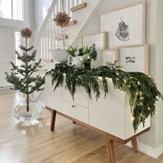 christmas decorations are on display under the stairs