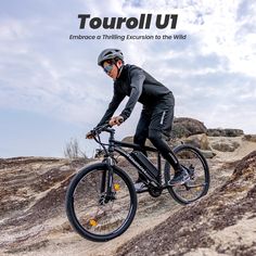 a man riding a bike on top of a dirt hill with the words tourollu written above it