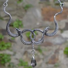 Intertwined Snakes With Poison Drop Necklace in 4 - Mounteen Spiritual Snake-shaped Metal Jewelry, Spiritual Metal Jewelry In Snake Shape, Mystical Silver Necklace For Party, Symbolic Metal Clavicle Chain Jewelry, Silver Mystical Jewelry For Party, Mystical Silver Jewelry For Party, Silver Snake Jewelry With Adjustable Chain, Symbolic Pewter Jewelry With Adjustable Fit, Gothic Sterling Silver Chain Jewelry