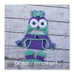 a crocheted owl hat and booties on a white wooden background with the words ocean / amethyst written below it