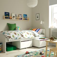 a child's bedroom with toy cars and toys on the floor