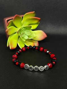 Black & Red Dance Stretchy Bracelet About the product  Colors: Black & red  Materials: Glass & Acrylic  * This one of a kind bracelet would be perfect to bring a smile to your friends and family. It is lightweight and fashionable, as well as stretchy. It's the perfect gift for family members or friends that love dance! * Contact and Follow Us!  If you have any questions about this bracelet feel free to message us on Etsy. We will be happy to answer them.  Shop our store:  https://www.etsy.com/shop/Toparadiseandbeyond Facebook: https://m.facebook.com/To-Paradise-And-Beyond-194702878032699/ Instagram: https://www.instagram.com/toparadiseandbeyondco/ Casual Black Beaded Bracelets For Valentine's Day, Black Bracelets For Party On Valentine's Day, Adjustable Red Stretch Bracelet Casual Style, Red Adjustable Stretch Bracelet, Personalized, Adjustable Red Stretch Bracelet For Valentine's Day, Red Adjustable Personalized Stretch Bracelet, Adjustable Personalized Red Stretch Bracelet, Trendy Black Bracelets For Valentine's Day, Trendy Black Bracelet For Valentine's Day