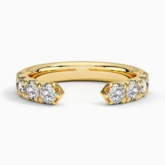 a yellow gold ring with three diamonds on it