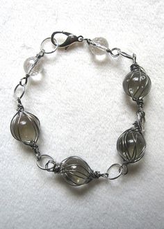 a silver bracelet with glass beads on it