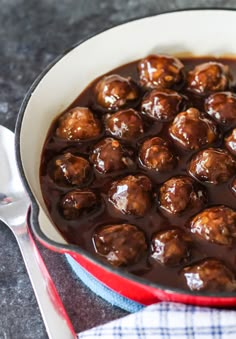 meatballs with sauce in a red skillet