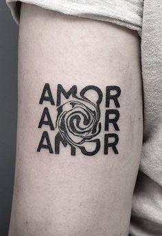 a woman with a black and white tattoo on her arm that reads,'amo arr '