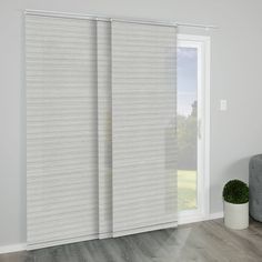 a living room with sliding glass doors that have vertical blinds on the outside and inside