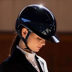 a woman wearing a black helmet and white shirt