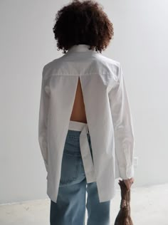 The Open Back Shirt remains faithful to your favourite oversized white shirt while including elements of the unexpected for a contemporary feel. Featuring concealed buttons, french cuffs and an open back with adjustable belt, the Open Back Shirt is crafted from 100% BCI Cotton for easy, everyday wear. Perfect for transitioning seamlessly from work to leisure, the Open Back Shirt is a refined staple for the modern, minimalist dresser. Materials 100% BCI Cotton Garment Details Concealed buttons, collar, french cuff, open back with adjustable belt. Manufacturing Manufacturer has signed the St. Agni Code of Conduct OEKO-TEX 100 certification Responsibly made in China Blouse Open Back, Minimalist Dresser, Dresser Minimalist, Dear Society, Open Back Shirt, Corporate Work, Oversized White Shirt, White Ankle Boots, St Agni