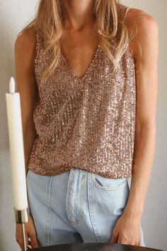 Sparkle All the Way!With shimmery and delicate sequins, this eye-catching top is ready to be worn on your next rendezvous! Makes for perfect pairing for jeans or dressier shorts, add a layer of your favorite blazer on those cooler nights. Materials & Care - Content: 95% Polyester, 5% Spandex- Care: Machine wash cold, tumble dry low, cool iron if needed- Made in the USA Size & Description -V neckline-Tank Top-Sequin-Lined-Loose Fit-Model is wearing size S Glamorous V-neck Top For Night Out, Glamorous V-neck Top For Parties, Glamorous V-neck Tops For Date Night, Trendy Shimmer Tops For Party, V-neck Shimmer Tops For Party Season, Trendy V-neck Party Tops, Glamorous Fall Top With Contrast Sequin, Glamorous Contrast Sequin Blouse For Night Out, Glamorous Sequin Blouse For Night Out