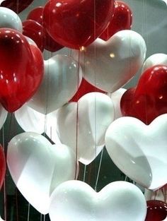 red and white heart shaped balloons hanging from strings