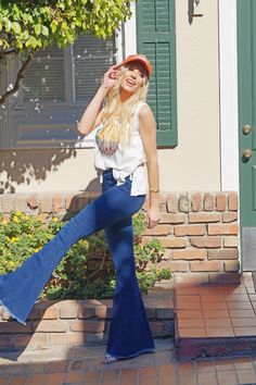 The best looking Bell Bottoms since the 70's! High waisted elastic waist with the perfect amount of stretch! Back pockets for convenience. Fringe bottoms take it to the next level. Believe us you need this. Definitely a wardrobe essential. Model is 5'9 and wearing a small Details Best Seller Fitted High Rise– True To Size 65% Cotton, 33% Polyester and 2% Spandex Machine Wash Cold, Inside Out, Tumble Dry Low Dark Wash Elastic Waistband Stretchy Fabrication Back Pockets Bell Bottom Raw Distressed Trendy Flare Bottoms For Day Out, Retro Stretch High Rise Pants, Retro High Rise Stretch Pants, Retro High-rise Stretch Pants, Casual Flare Bottoms With Elastic Waistband, Retro Stretch Bottoms With Elastic Waistband, Retro Mid-rise Summer Pants, High Rise Flare Jeans With Elastic Waistband For Spring, Spring High Rise Flare Jeans With Elastic Waistband