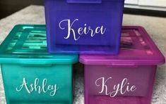 three plastic storage containers with names on them