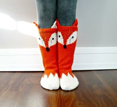 the legs of a person wearing knitted socks with foxes on them