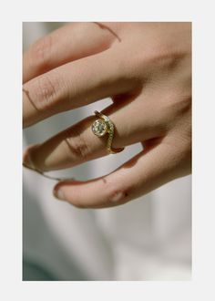 a woman's hand with a diamond ring on it