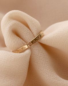 a gold ring sitting on top of a white cloth