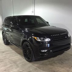 a black range rover parked in a garage