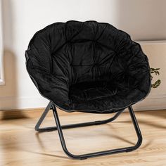 a black chair sitting on top of a hard wood floor