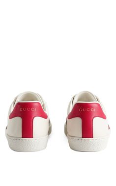 Low-top buffed leather sneakers in off-white. Round toe. Tonal lace-up closure. Padded collar. Logo printed in gold-tone at red buffed leather heel tab. Signature webbing stripes in red and green at sides. Graphic embroidered at outer side. Textured rubber midsole. Treaded rubber outsole. Tonal hardware. Supplier color: WhiteUpper: leatherSole: rubberMade in Italy Luxury High-top Sneakers With Contrasting Heel Counter, Red Sole Low-top Calf Leather Sneakers, Low-top Calf Leather Sneakers With Red Sole, Gucci Leather Sneakers With Contrast Sole, White Gucci Sneakers In Calf Leather, Gucci Lace-up Calf Leather Sneakers, White Gucci Calf Leather Sneakers, Gucci White Calf Leather Sneakers, Gucci Leather Sneakers