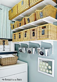 some baskets are hanging on the wall above a washer and dryer in this laundry room