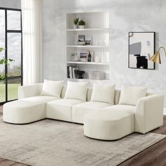 a living room with a large white sectional couch