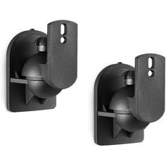 there are two black wall mounted speakers on the side of each speaker holder and one is holding an object in it's right hand