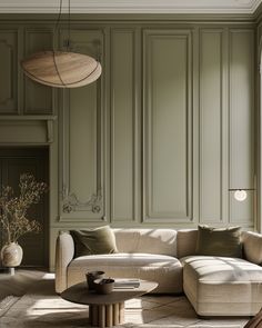 a living room filled with furniture and walls painted in shades of green, white and beige