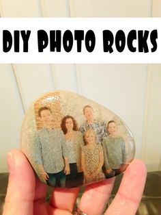 a hand holding up a rock with the words diy photo rocks on it