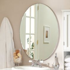 a bathroom with a sink, mirror and towel rack