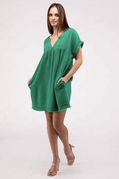 The Gauze Rolled Short Sleeve Raw Edge V-Neck Dress offers a breezy and relaxed style perfect for warm-weather occasions. With its rolled short sleeves and raw edge details, this dress exudes a casual and carefree vibe, making it ideal for summer outings. The V-neck adds a touch of femininity to the look, making this dress a comfortable yet fashionable choice for days at the beach or casual gatherings.Model is wearing a SmallModel SpecsHeight: 5'9"Bust: 35B Waist: 24"Hips: 34"Made in Vietnam Sty Casual V-neck Short Sleeve Dress For Vacation, Summer V-neck Mini Dress With Relaxed Fit, Relaxed Fit V-neck Mini Dress For Summer, Chic V-neck Short Sleeve Vacation Dress, Spring Cotton Dresses With Rolled Sleeves, Chic Green Short Sleeve Summer Dress, Relaxed Fit V-neck Mini Dress For Vacation, Casual Green Short Sleeve Dress For Spring, Casual Short Sleeve Summer Dress With Relaxed Fit