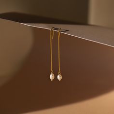 It’s as easy as pie to throw on our Pearl Threader Earrings and put an outfit together. Glamorous and dainty, these dangling charm earrings are minimalistic and perfectly stack with other earrings in your collection. Material: High Quality Solid 925 Sterling Silver Finish: 18K Gold ∙ Sterling Silver Featuring ~0.7mm Thick Chain Earrings ~60mm in Length, with a ~5.5x4.5mm Pearl Charm Sold as a pair Part of our Pearl Collection Model showcases a glamorous, event-ready look featuring Pearl Station Everyday Delicate Chain Gold-plated Earrings, Everyday Gold-plated Earrings With Delicate Chain, Gold Plated Delicate Chain Earrings For Everyday, Everyday Dainty Dangle Linear Earrings, Everyday Gold Plated Delicate Chain Earrings, Minimalist Gold Plated Threader Earrings, Minimalist Tarnish Resistant Dangle Threader Earrings, Minimalist Single Pearl Earring For Everyday Elegance, Minimalist Tarnish-resistant Pearl Earrings As Gift