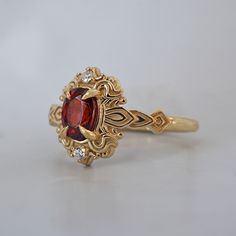 Read about our payment plans before proceeding. In the heart of this exquisite Faith ring, a crimson spinel nestles, a gem of nature's tender artistry. Embraced by delicate scroll-like motifs, each curve whispers tales of timeless elegance, bestowing upon it a vintage flair that dances with the echoes of ages past. Crafted by skilled hands, this ring is available in your choice of 14K and 18K yellow gold, rose gold, and white gold. All orders come in our Tippy Taste ring box. This ring is handma Luxury Red Sapphire Wedding Ring, Heirloom Ruby Ring With Gemstone Accents Gift, Heirloom Ruby Ring With Gemstone Accents As A Gift, Heirloom Ruby Ring With Gemstone Accents, Elegant Red Birthstone Ring With Rose Cut Diamonds, Luxury Red Birthstone Ring In 14k Gold, Luxury 14k Gold Red Birthstone Ring, Luxury Red 14k Gold Birthstone Ring, Fine Jewelry Red Ruby Ring With Intricate Design