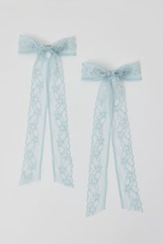 Mid-sized hair barrettes topped with oversized bows crafted from sheer lace. Sod in a set of two. Content + Care. Set of 2 Textile, mixed metal Spot clean Imported