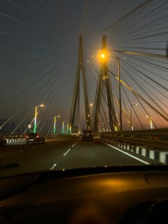 cars driving on a bridge at night time