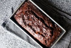 a loaf of chocolate cake sitting on top of a table