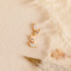 If elegance is your goal, look no further than our Opal & Diamond Marquise Studs. With their mismatched design and delicate nature, these earrings add a touch of uniqueness while still remaining classic. Give as a meaningful gift to your bridesmaids so they may all remember the special day. Material: High Quality Solid 925 Sterling Silver Finish: 18K Gold ∙ Sterling Silver Featuring ~5x2mm Marquise Opal & Diamond Gemstones Sold as a pair Part of our Opal Collection Model showcases a understated, Initial Tag Necklace, Sideways Initial Necklace, Dainty Initial Necklace, Stud Set, Tag Necklace, Birthstone Ring, Diamond Studs, Diamond Gemstone, Initial Necklace