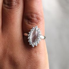 This Sterling Silver Ring features an Elegant Art With Natural Moonstone Gemstone. The cavity is made from genuine solid 925 sterling silver and stamped as S925. This Jewelry is Lead free and Rhodium Plated to keep polish long time and Scratches free. ITEM DESCRIPTION Item Code: JARG337/12 Metal: 925/92.5 Sterling Silver Gemstone: Genuine Natural Moonstone Cabochon Gemstone Shape: Marquise Gemstone Size: 6 X 12 MM Ring Length: 18 MM Ring width: 11 MM Second Stone: Cubic Zirconia Weight: 3.2 gm a Sterling Silver Moonstone Ring For Anniversary, Heirloom Style Moonstone Ring For Wedding In Sterling Silver, Silver Sterling Silver Halo Ring, Silver Sterling Moonstone Wedding Ring, Sterling Silver Moonstone Wedding Ring, Fine Jewelry Sterling Silver Moonstone Wedding Ring, Unique Silver Marquise Jewelry, Delicate Sterling Silver Crystal Ring For Anniversary, Dainty Sterling Silver Moonstone Ring For Wedding