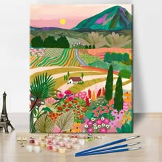 the painting is on display next to some paintbrushes and other art supplies, including an eiffel tower in the background