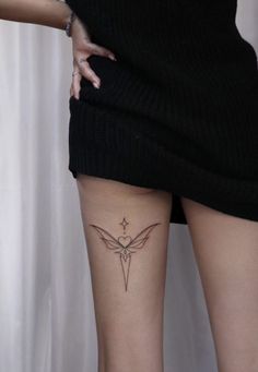 a woman with a small tattoo on her thigh