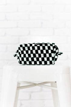 The Sweetest Thing Pouch is perfect for storing your makeup, pens/pencils, or even for keeping in the car to hold all your on-the-go essentials! Whatever it is, we know you'll get lots of use out of this multi use pouch. Featuring a checkered print knit material with inner lining and a zip closure. Lined + Zipper closure 11" x 4.5" x 3" Keywords: Pouch, Makeup Bag, Checker Print Trendy Black Pencil Case For School, Black Pencil Case Pouch For Everyday Use, Trendy Black Travel Pencil Case, Black School Bags With Pen Holders, Black Pouch Cosmetic Bag For School, Black Pencil Case With Pen Holders For Travel, Trendy Black Pouch Cosmetic Bag, Black Pouch With Pen Holders For School, Rectangular Cosmetic Bag With Pen Holders For Storage