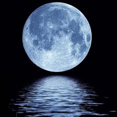 a full moon is reflected in the water