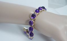 Visit the store of our partners here - https://www.etsy.com/shop/jewelsdirect?ref=search_shop_redirect  For most of our items more pictures available. This gorgeous estate bracelet is finely crafted in solid 14K Yellow gold and it is set with genuine Earth mined Amethyst cabochons. Each gem is 10mmx 8mm for the total weight 32.06 carats. These cabochons are great quality stones of a good intensity.  The bracelet is 7 inches long and8mm thick. Perfectly working clasp. ... Formal Amethyst Round Bracelets, Formal Round Amethyst Bracelets, Formal Amethyst Bracelets, Purple Round Tennis Bracelet For Formal Occasions, Purple Princess, Everyday Bracelet, Purple Bracelet, Elegant Bracelet, Amethyst Bracelet