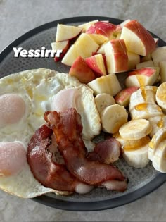 an english breakfast on a plate with apples and bananas