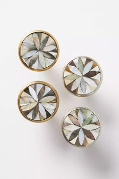 three pairs of diamond shaped knobs on a white surface