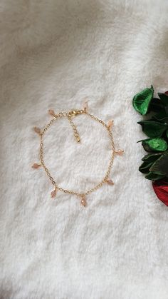 "This bracelet is made with natural Sunstone beads (4 mm), gold plated chain and gold plated clasp.  The length of the extension is approximately 1inch (excluding the bracelet length). The number of the beads which wrapped in the chain is 9 beads.  Measure with a non-stretchy string or flex tape above your ankle bone and add 1/2\". For example; if your ankle measures 8\", you will need a 8¼ - 8¾\" anklet. This will allow room to loosen or tighten the beaded anklet to fit just right. Please note: store your jewellery individually to keep them from scratching each other. Avoid contact with perfume, body lotions, hairspray or any other chemical. Also available in real platinum plated. Please contact me in case you have any questions." Adjustable Gold Charm Bracelet With Beaded Chain, Gold Beaded Dangle Charm Bracelet, Gold Dainty Crystal Bracelet With Adjustable Chain, Gold Crystal Bracelet With Adjustable Chain, Dainty Style, Dainty Gold Crystal Bracelet With Adjustable Chain, Handmade Minimalist Gold Crystal Bracelet, Minimalist Handmade Gold Crystal Bracelet, Gold Crystal Bracelet With Beaded Chain For Gift, Handmade Dainty Gold Crystal Bracelet