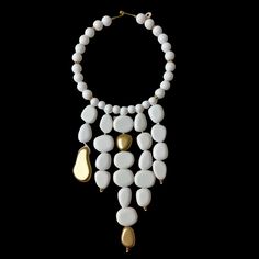 This elegant choker necklace measures 16 inches, complemented by a striking strand of beads that extends to 28 inches.   Featuring dangling acrylic white beads adorned with gold accent beads, this versatile piece serves as a bold statement accessory suitable for both formal and informal occasions.  The pure white beads create a stunning visual impact, ensuring this necklace stands out effortlessly in any setting. Elegant Choker, Necklace Stand, White Necklace, Gold Accent, The Pure, White Beads, Pure White, Gold Accents, Choker