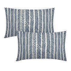 two blue and white pillows on a white background