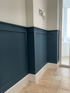 an empty room with blue walls and white trim on the wall is pictured in this image